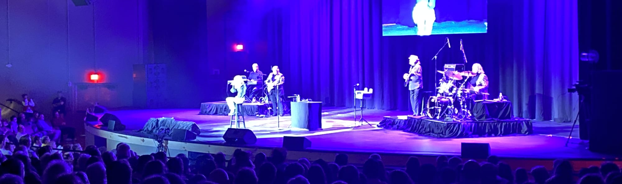 signer on stage in chair washed out by the lights Wichita